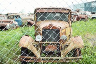 old rusted car in junkyard