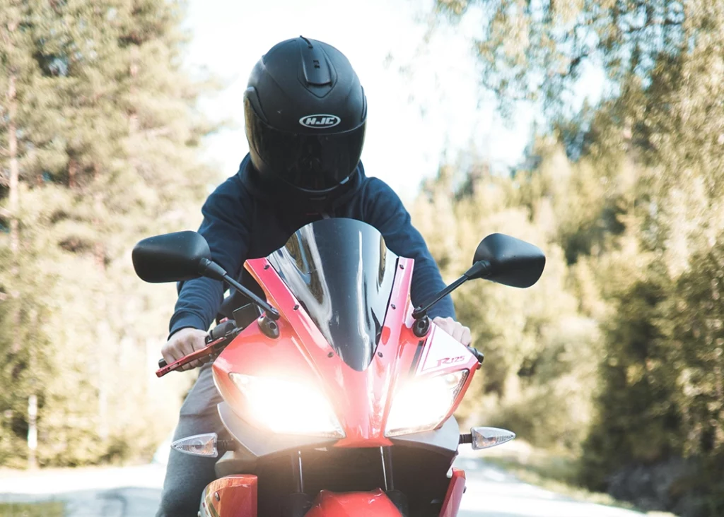 man riding motor bike with motorcycle helmet