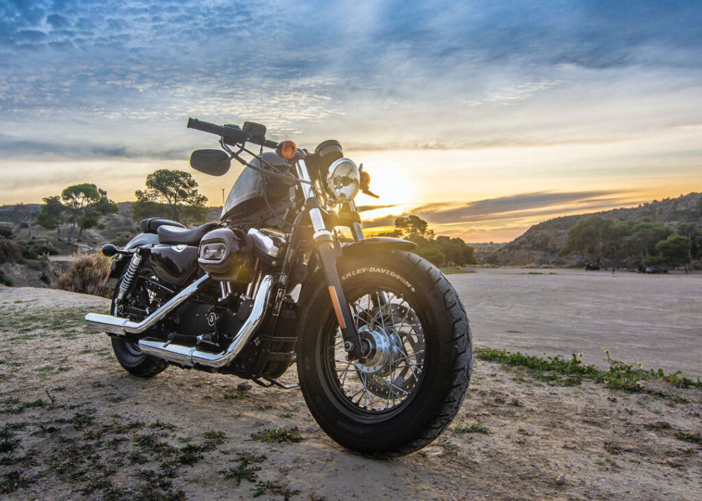 motorcycle in the sandy desert with sunset